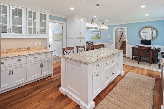 37 Woodridge Cir, New Canaan, CT 06840 - kitchen featuring ornamental molding, white cabinets, glass insert cabinets, a kitchen island, and hanging light fixtures