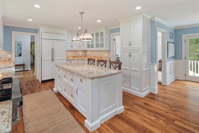 37 Woodridge Cir, New Canaan, CT 06840 - kitchen with wood finished floors, baseboard heating, white cabinetry, stainless steel range with gas cooktop, and ornamental molding