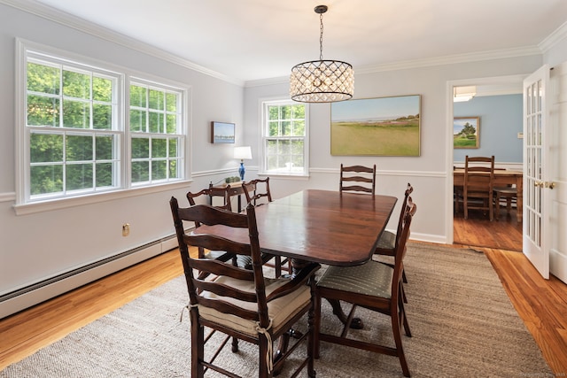 37 Woodridge Cir, New Canaan, CT 06840 - dining space with light wood-style floors, a baseboard heating unit, crown molding, and a chandelier