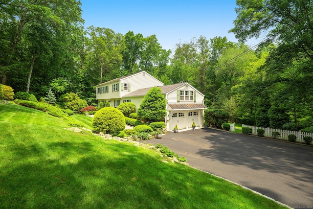 37 Woodridge Cir, New Canaan, CT 06840 - view of front of property with asphalt driveway and an attached garage