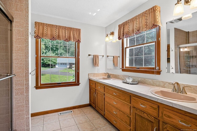 175 Wrights Brook Dr, Somers, CT 06071 - bathroom featuring double vanity, a shower stall, plenty of natural light, and tile patterned floors