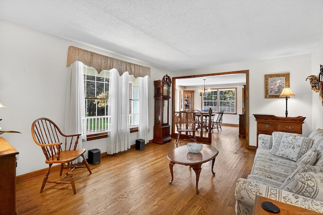 175 Wrights Brook Dr, Somers, CT 06071 - living room with a textured ceiling, wood finished floors, and a chandelier