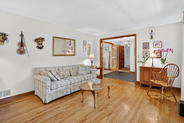 175 Wrights Brook Dr, Somers, CT 06071 - living area with light wood-style floors and a chandelier