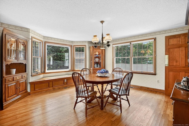175 Wrights Brook Dr, Somers, CT 06071 - dining area with wallpapered walls, light wood finished floors, a textured ceiling, and a chandelier