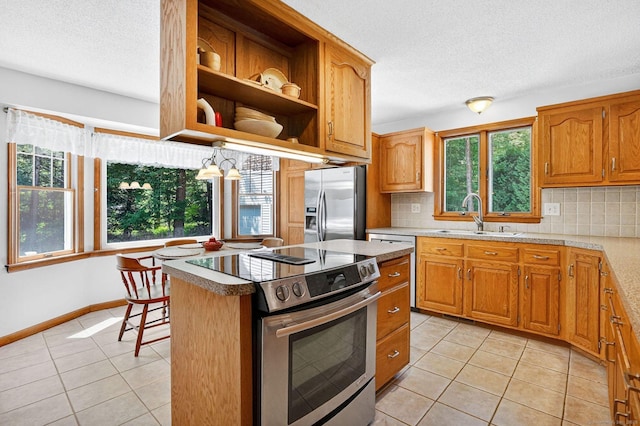 175 Wrights Brook Dr, Somers, CT 06071 - kitchen with stainless steel appliances, plenty of natural light, a textured ceiling, decorative backsplash, and light tile patterned floors