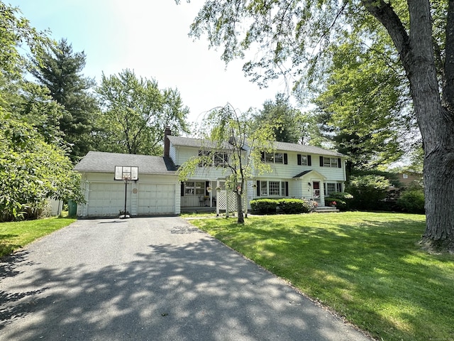 55 Kenwood Cir, Bloomfield, CT 06002 - colonial home with a garage, driveway, a front yard, and a chimney