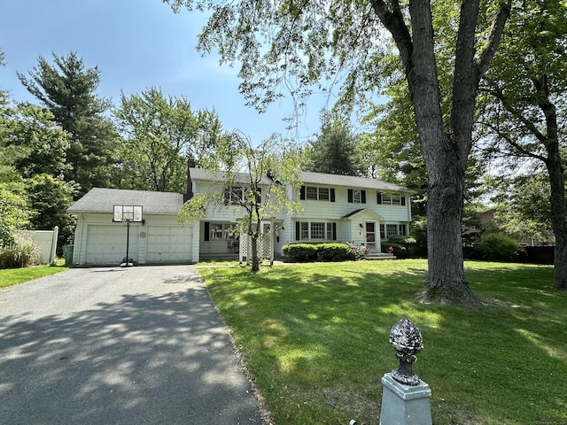 55 Kenwood Cir, Bloomfield, CT 06002 - colonial inspired home featuring a garage, asphalt driveway, a front yard, and a chimney