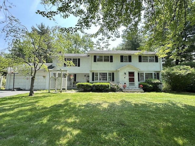 55 Kenwood Cir, Bloomfield, CT 06002 - view of front facade featuring a front lawn, a garage, and asphalt driveway