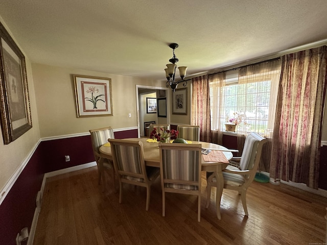 55 Kenwood Cir, Bloomfield, CT 06002 - dining room featuring a chandelier, wood finished floors, a textured ceiling, and baseboards