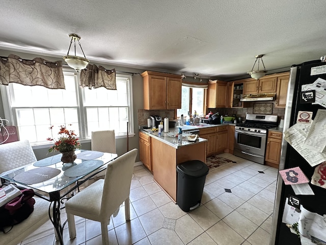 55 Kenwood Cir, Bloomfield, CT 06002 - kitchen with stainless steel appliances, a peninsula, brown cabinets, under cabinet range hood, and backsplash