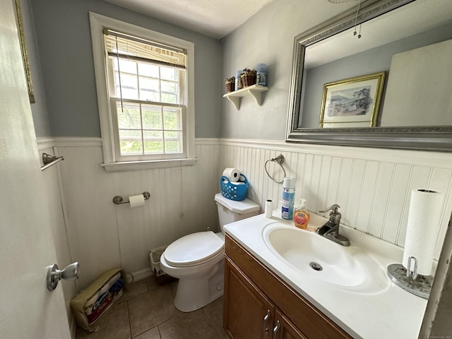 55 Kenwood Cir, Bloomfield, CT 06002 - bathroom with a wainscoted wall, toilet, vanity, and tile patterned floors