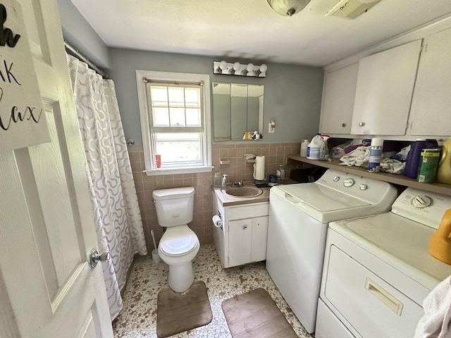 55 Kenwood Cir, Bloomfield, CT 06002 - laundry area with independent washer and dryer, tile walls, and a wainscoted wall