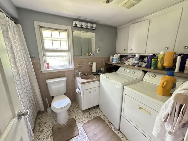 55 Kenwood Cir, Bloomfield, CT 06002 - laundry room with independent washer and dryer, tile walls, and wainscoting