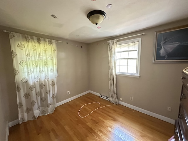 55 Kenwood Cir, Bloomfield, CT 06002 - unfurnished bedroom with wood finished floors and baseboards