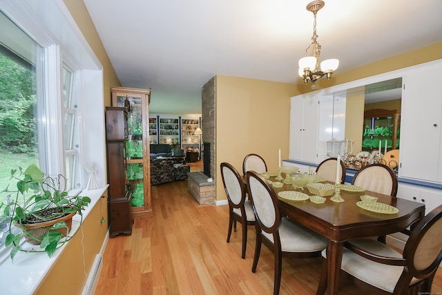 100 Ridgebrook Rd, Torrington, CT 06790 - dining space featuring a chandelier, light wood-style flooring, and a fireplace