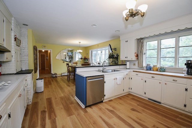 100 Ridgebrook Rd, Torrington, CT 06790 - kitchen with stainless steel dishwasher, a chandelier, a sink, white cabinets, and a peninsula