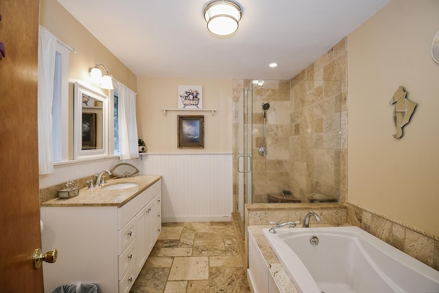 100 Ridgebrook Rd, Torrington, CT 06790 - full bath featuring stone tile flooring, a shower stall, a bath, vanity, and wainscoting