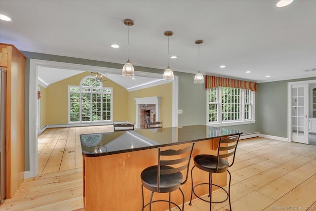 47 Cricket Ln, Somers, CT 06071 - kitchen featuring light wood-style floors, crown molding, a kitchen island, healthy amount of natural light, and dark stone counters