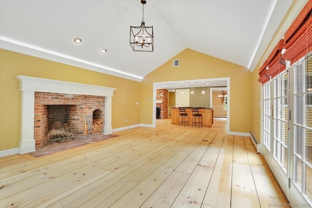 47 Cricket Ln, Somers, CT 06071 - unfurnished living room featuring light wood-type flooring, high vaulted ceiling, baseboard heating, baseboards, and bar area