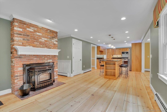 47 Cricket Ln, Somers, CT 06071 - kitchen featuring a baseboard heating unit, crown molding, a kitchen bar, light wood-type flooring, and recessed lighting