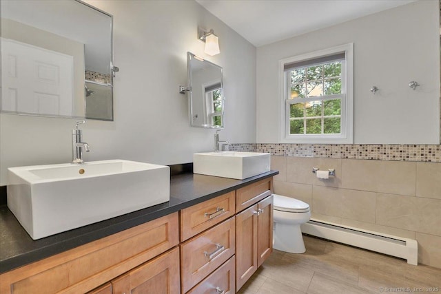 47 Cricket Ln, Somers, CT 06071 - full bath with baseboard heating, double vanity, tile walls, toilet, and a wainscoted wall