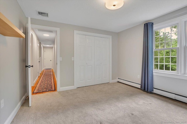 47 Cricket Ln, Somers, CT 06071 - unfurnished bedroom with carpet flooring, a closet, baseboards, and baseboard heating