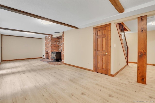 47 Cricket Ln, Somers, CT 06071 - unfurnished living room featuring beam ceiling, wood finished floors, stairs, baseboards, and a wood stove