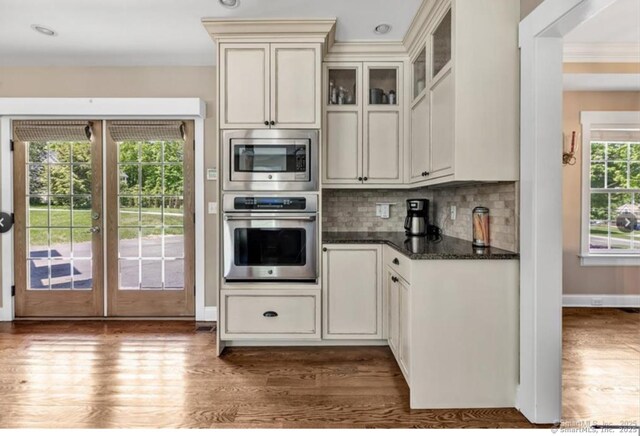 57 Church St, Shelton, CT 06484 - kitchen featuring stainless steel appliances, dark wood-type flooring, tasteful backsplash, french doors, and dark stone counters