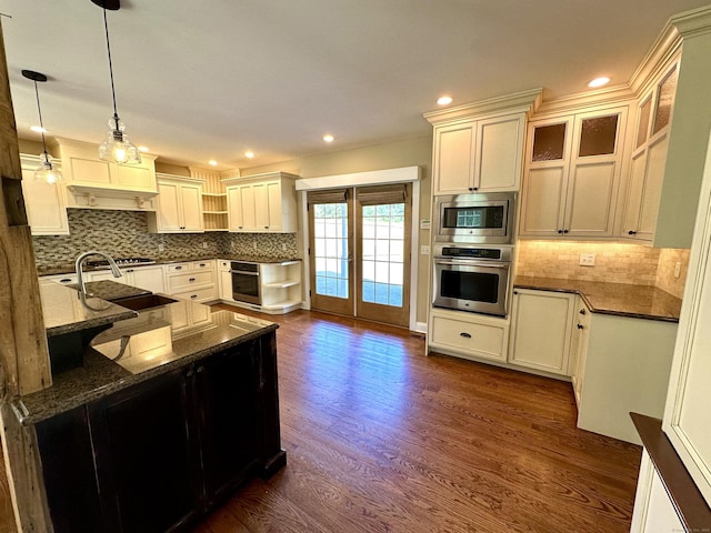 57 Church St, Shelton, CT 06484 - kitchen with stainless steel appliances, dark wood-style floors, backsplash, pendant lighting, and dark stone countertops