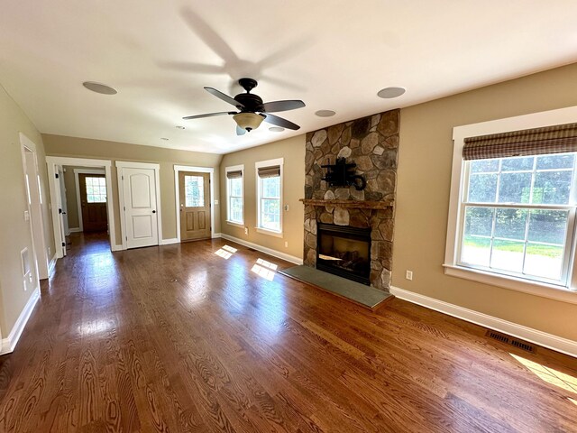 57 Church St, Shelton, CT 06484 - unfurnished living room with ceiling fan, dark wood-style flooring, and a stone fireplace