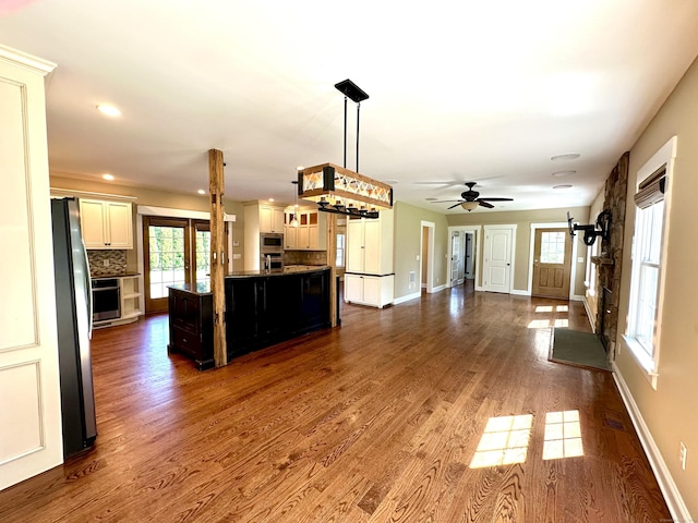57 Church St, Shelton, CT 06484 - kitchen with open floor plan, decorative backsplash, appliances with stainless steel finishes, dark wood-style floors, and a ceiling fan