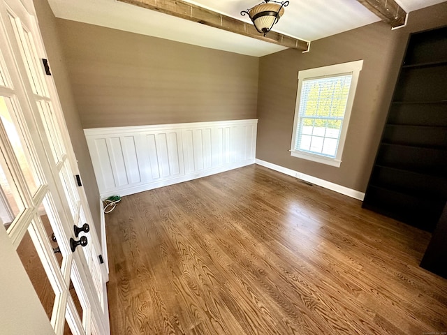 57 Church St, Shelton, CT 06484 - unfurnished room featuring beam ceiling, a wainscoted wall, and wood finished floors