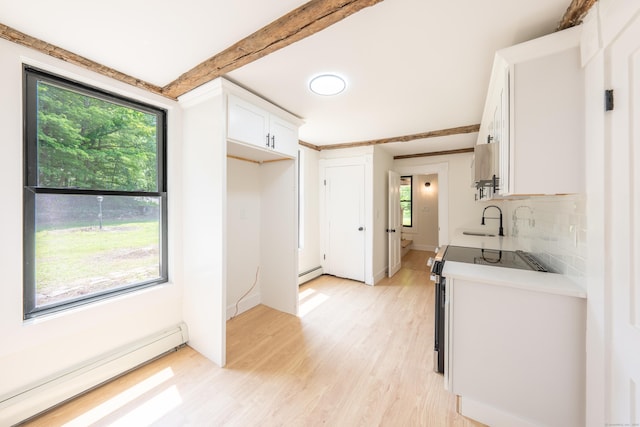 219 Redding Rd, Redding, CT 06896 - kitchen with a baseboard heating unit, range with electric cooktop, light wood finished floors, baseboard heating, and white cabinets
