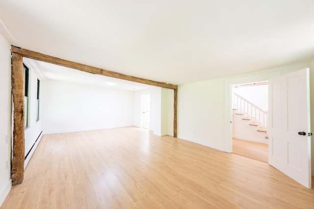 219 Redding Rd, Redding, CT 06896 - unfurnished living room featuring light wood-type flooring, stairs, and a baseboard radiator