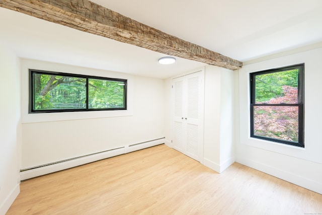 219 Redding Rd, Redding, CT 06896 - unfurnished bedroom with a baseboard radiator, light wood-type flooring, and a closet