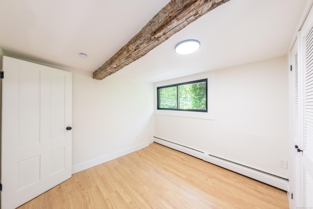 219 Redding Rd, Redding, CT 06896 - unfurnished bedroom with baseboard heating, wood finished floors, beamed ceiling, and a closet