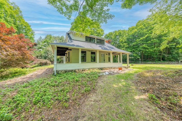 219 Redding Rd, Redding, CT 06896 - view of front of house with a shingled roof, a wooded view, and covered porch