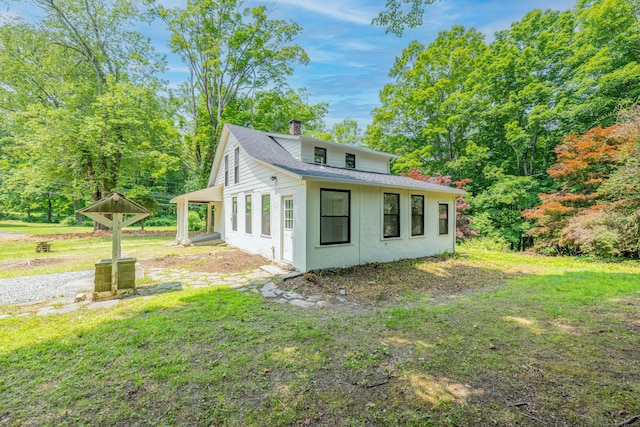 219 Redding Rd, Redding, CT 06896 - view of home's exterior featuring a chimney, a shingled roof, and a lawn