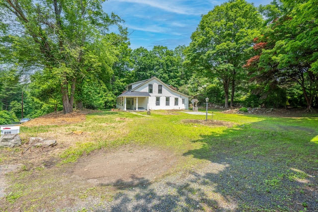 219 Redding Rd, Redding, CT 06896 - view of green lawn with a forest view and a porch