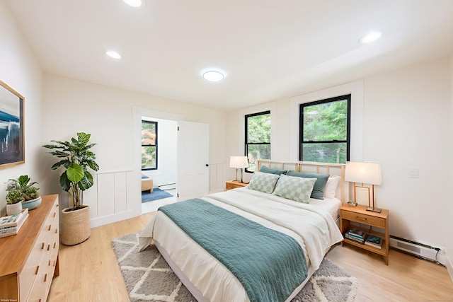 219 Redding Rd, Redding, CT 06896 - bedroom featuring a baseboard heating unit, wood finished floors, and recessed lighting