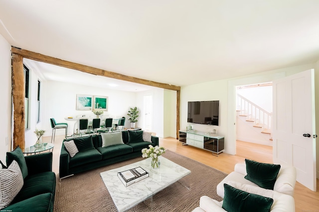219 Redding Rd, Redding, CT 06896 - living area featuring stairs, light wood-type flooring, and beamed ceiling