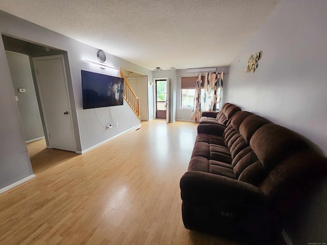 181 Cypress Rd Unit 181, Newington, CT 06111 - living area with stairway, a textured ceiling, and light wood-style floors