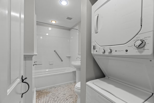 75 Harrison Ave, Wallingford, CT 06492 - full bath with estacked washer and dryer, shower / bath combination, and tile patterned floors