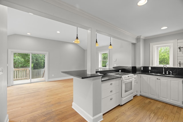 75 Harrison Ave, Wallingford, CT 06492 - kitchen featuring white range with electric stovetop, dark countertops, light wood-style floors, a peninsula, and ornamental molding