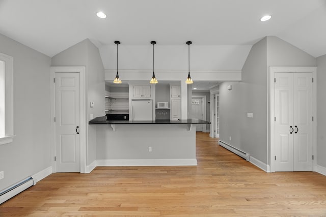 75 Harrison Ave, Wallingford, CT 06492 - kitchen featuring white appliances, baseboard heating, lofted ceiling, dark countertops, and a peninsula