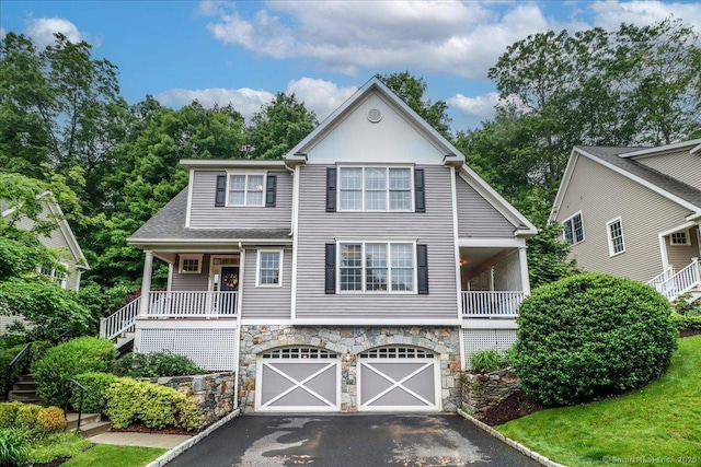 22 Woods Way Unit 22, Redding, CT 06896 - view of front facade featuring stairway, stone siding, asphalt driveway, an attached garage, and covered porch