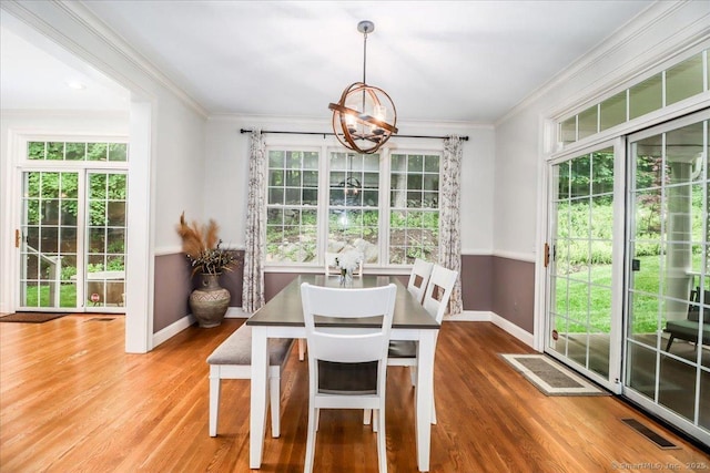 22 Woods Way Unit 22, Redding, CT 06896 - dining area with a chandelier, healthy amount of natural light, wood finished floors, and crown molding