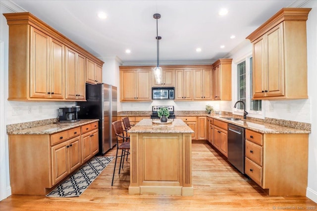 22 Woods Way Unit 22, Redding, CT 06896 - kitchen featuring appliances with stainless steel finishes, a kitchen island, light wood finished floors, a breakfast bar area, and crown molding