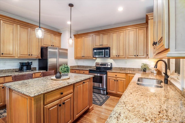 22 Woods Way Unit 22, Redding, CT 06896 - kitchen featuring stainless steel appliances, a kitchen island, light stone counters, light wood-type flooring, and crown molding