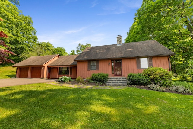 389 Chamberlain Rd, Middletown, CT 06457 - view of front of home with an attached garage, a front yard, a chimney, and driveway
